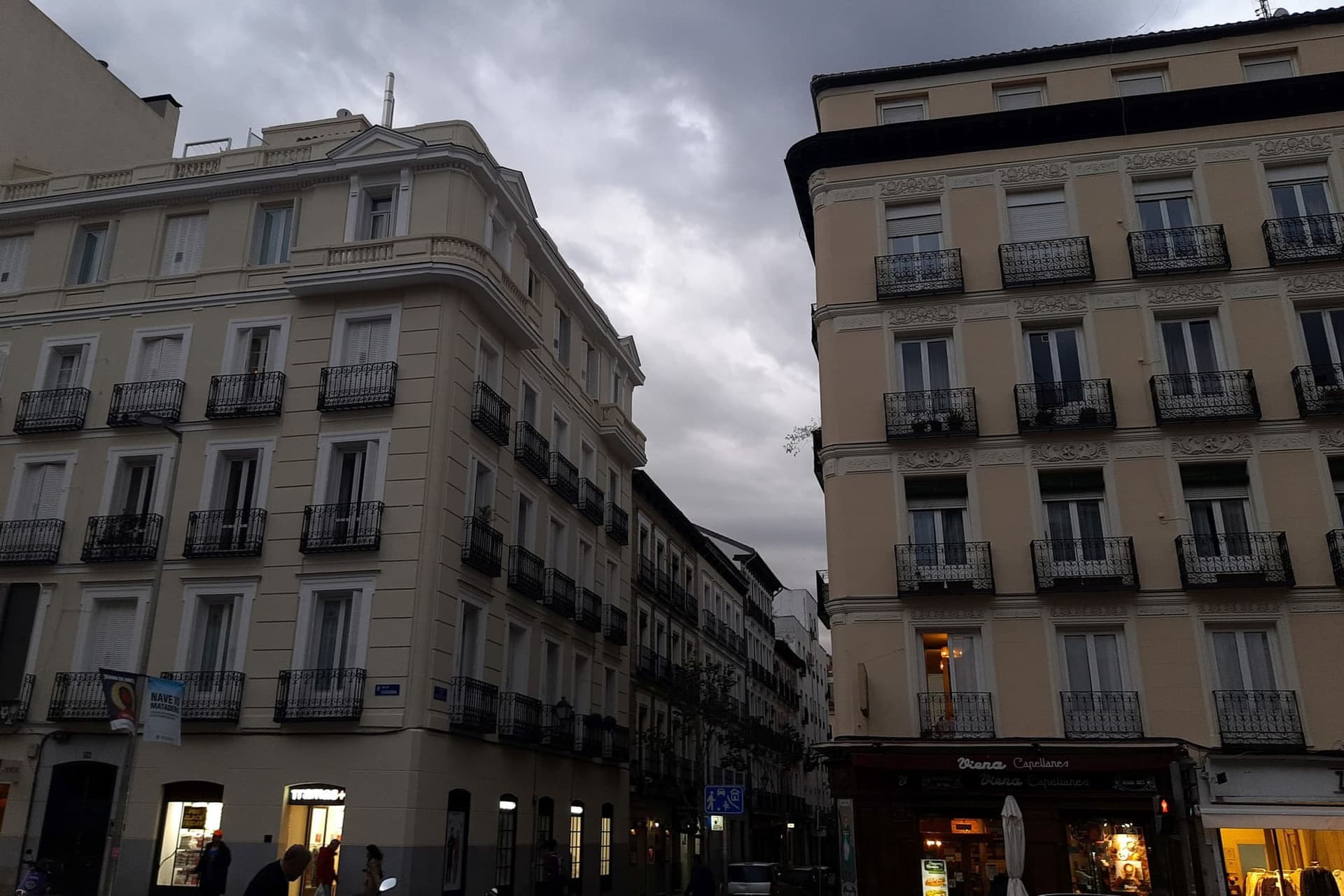 The pedestrianised Calle Fuencarral in Madrid, lined with shopfronts and busy with people.